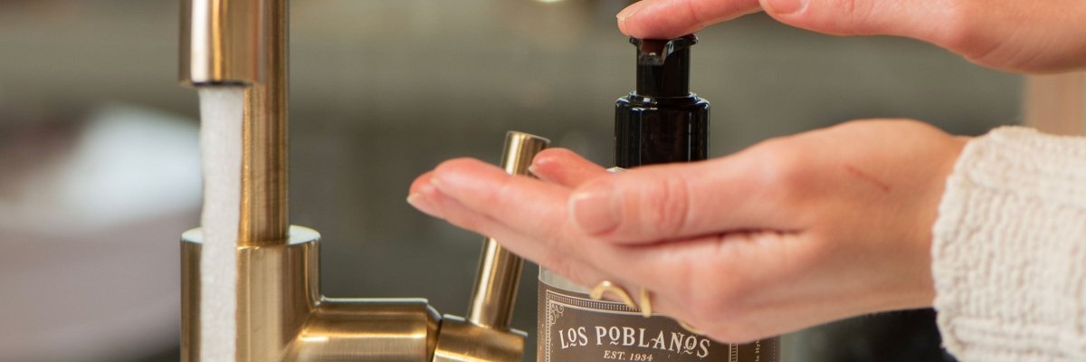 Person applying Los Poblanos body wash to their hand with a blurred background