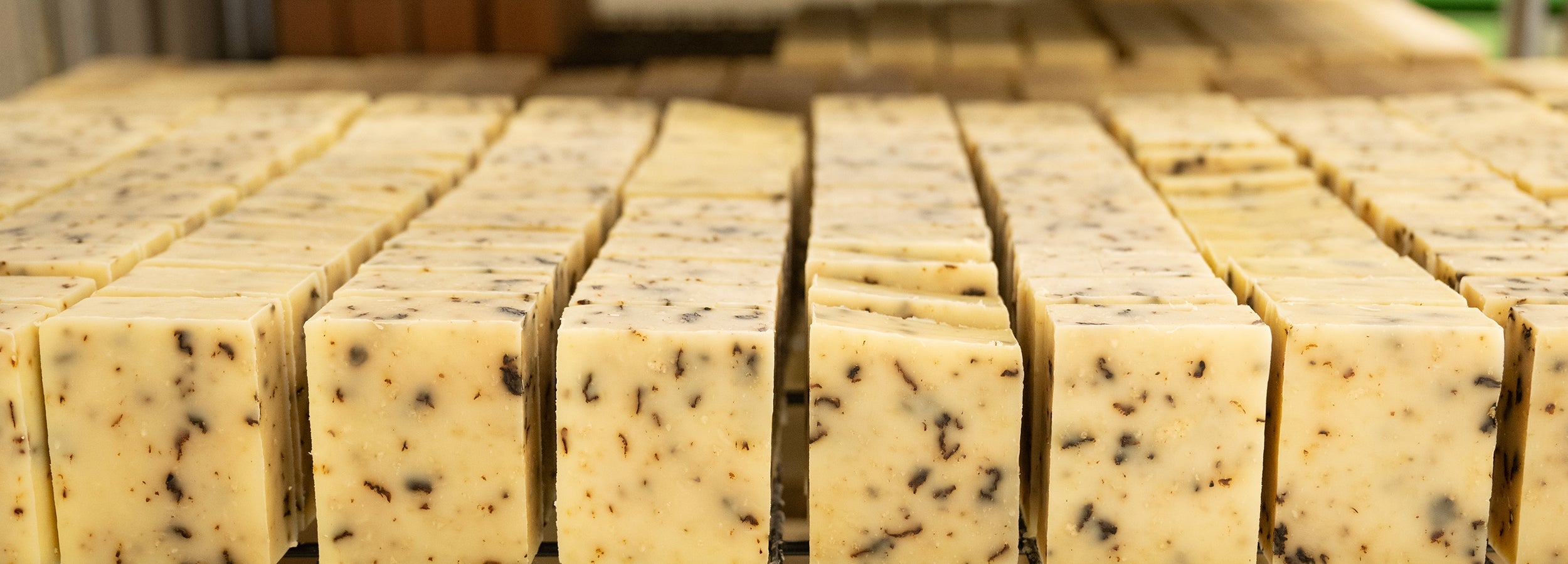 freshly made bars of soap on a metal rack.