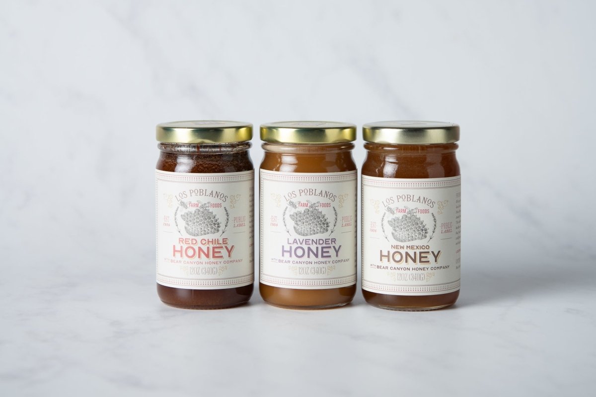 Three jars of honey from Los Poblanos on a white background