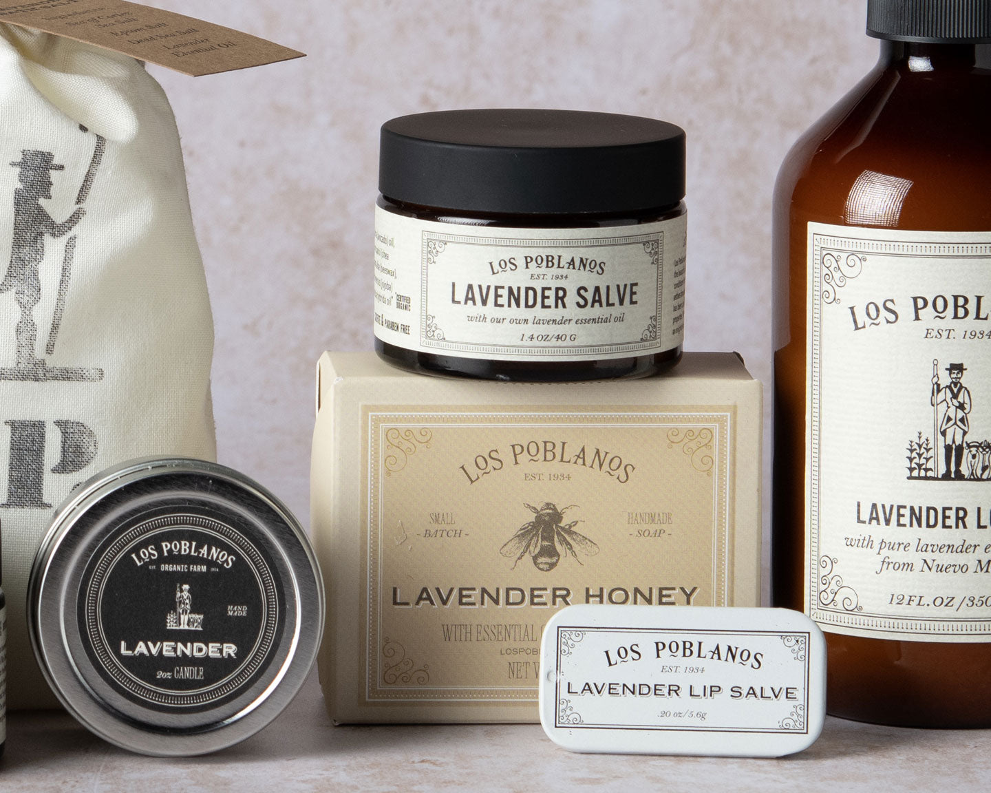 Collection of Los Poblanos lavender products including salves and soap on a neutral background.
