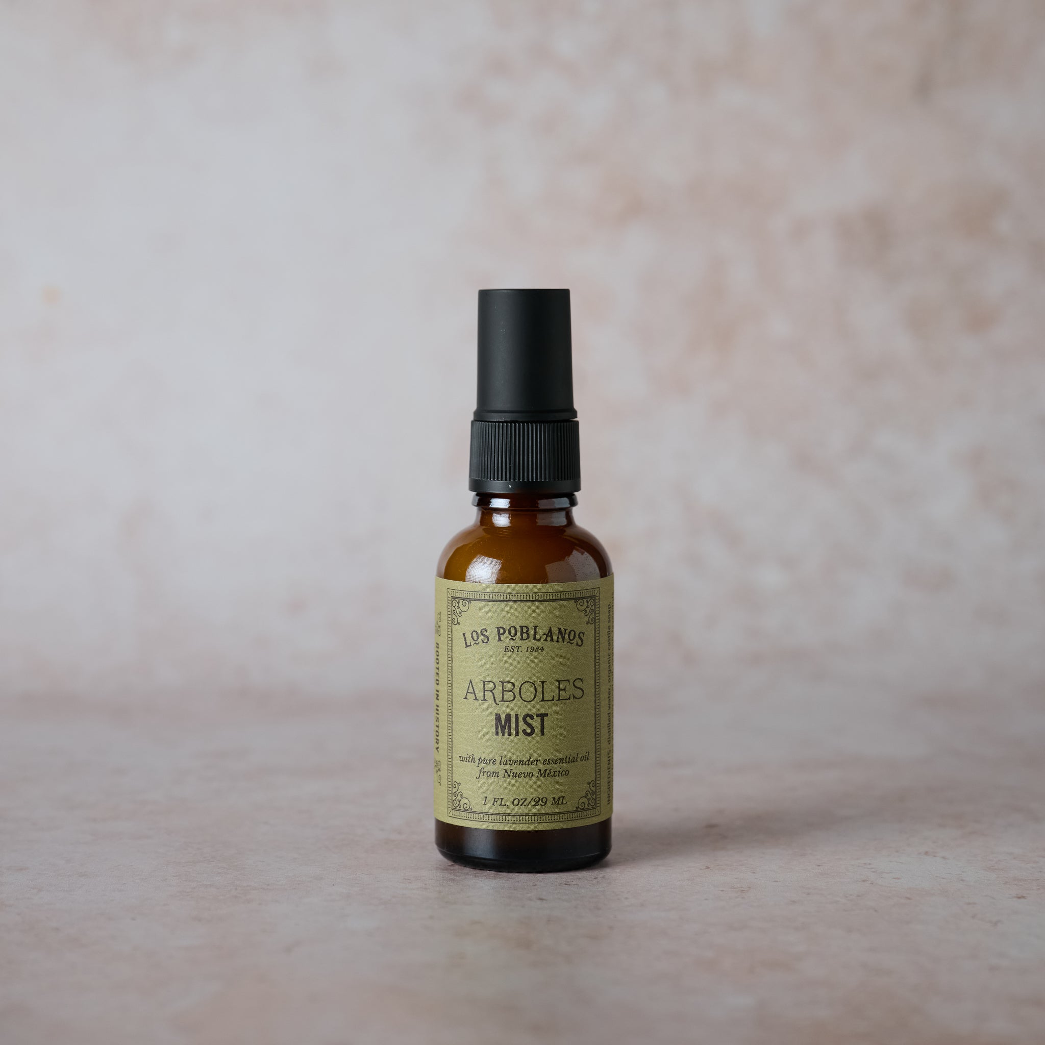 Los Poblanos arboles room and body mist in an amber glass bottle with a minimalist label.