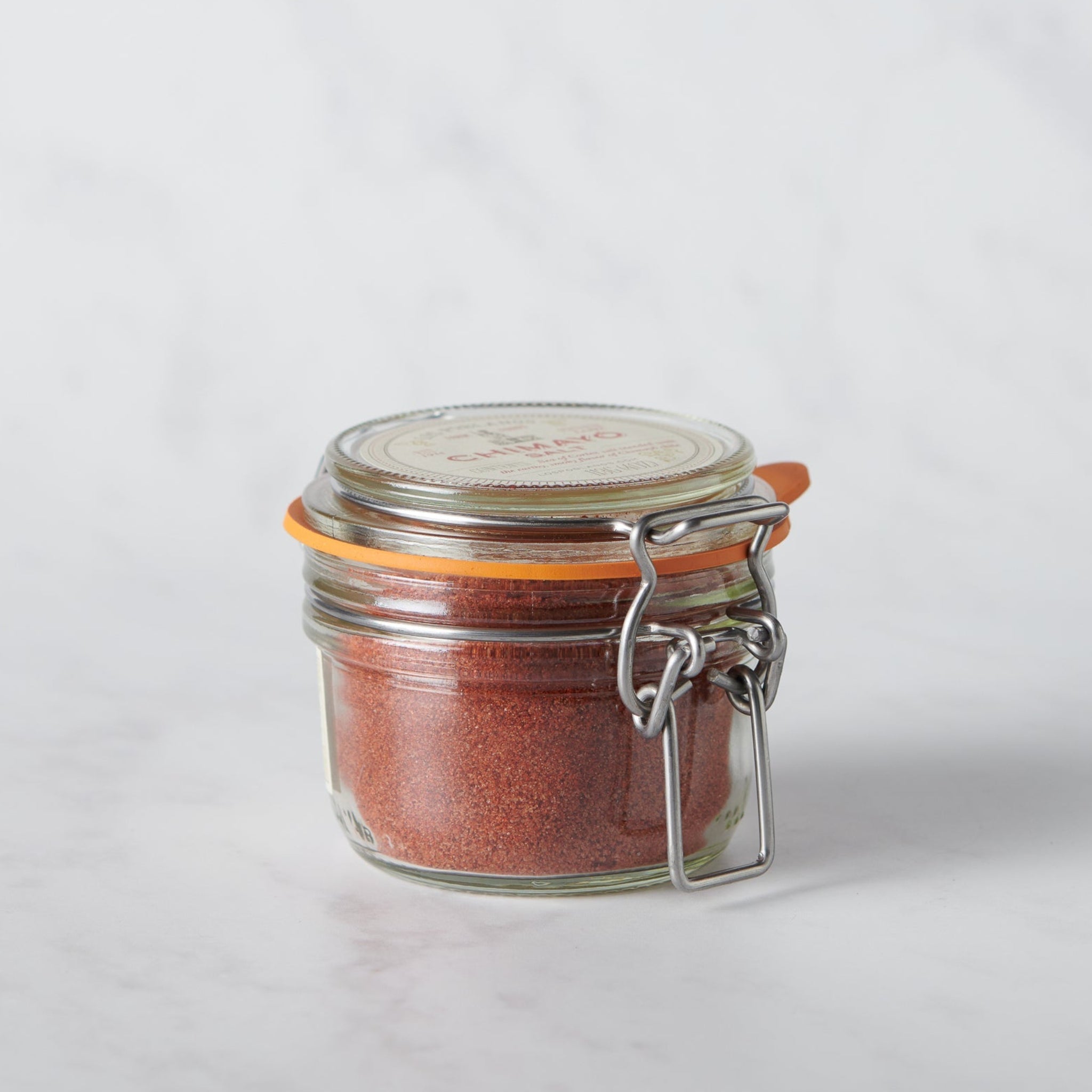 Chimayó Salt from Los Poblanos in a reusable glass jar featuring traditional New Mexican heirloom chile blended with sea salt.