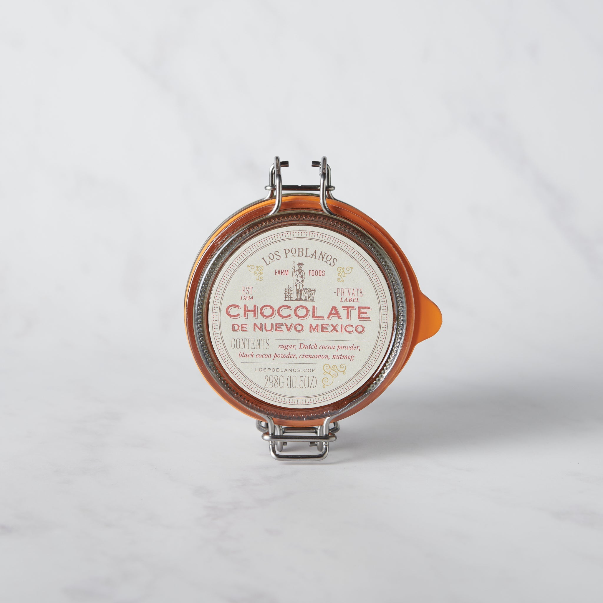 Chocolate de Nuevo México artisanal chocolate powder in a reusable glass jar inspired by regional flavors.