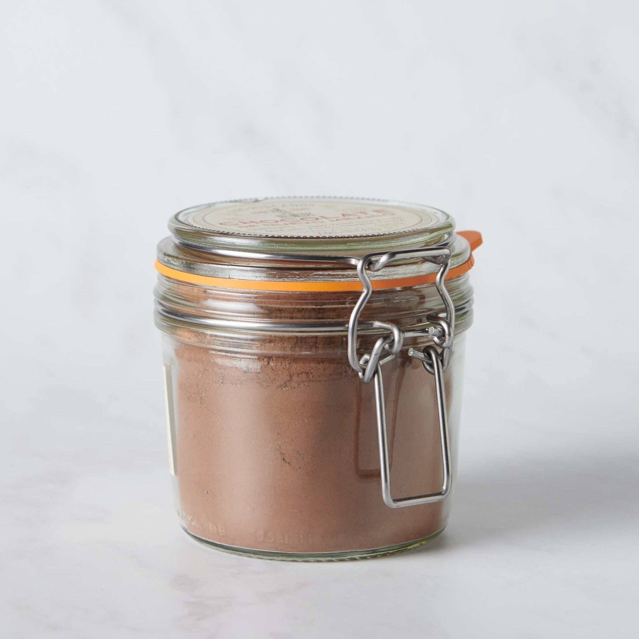 Chocolate de Nuevo México artisanal chocolate powder in a reusable glass jar inspired by regional flavors.