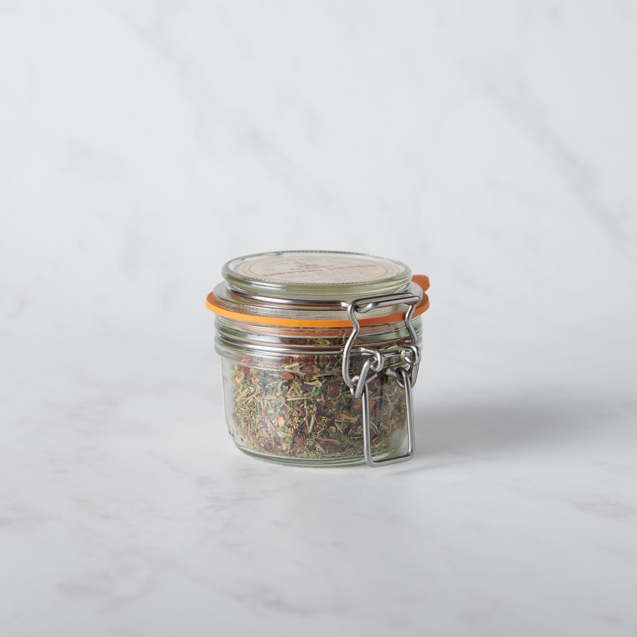Classic Dipping Herbs from Los Poblanos in a glass jar containing a savory blend of farm-grown lavender and spices.
