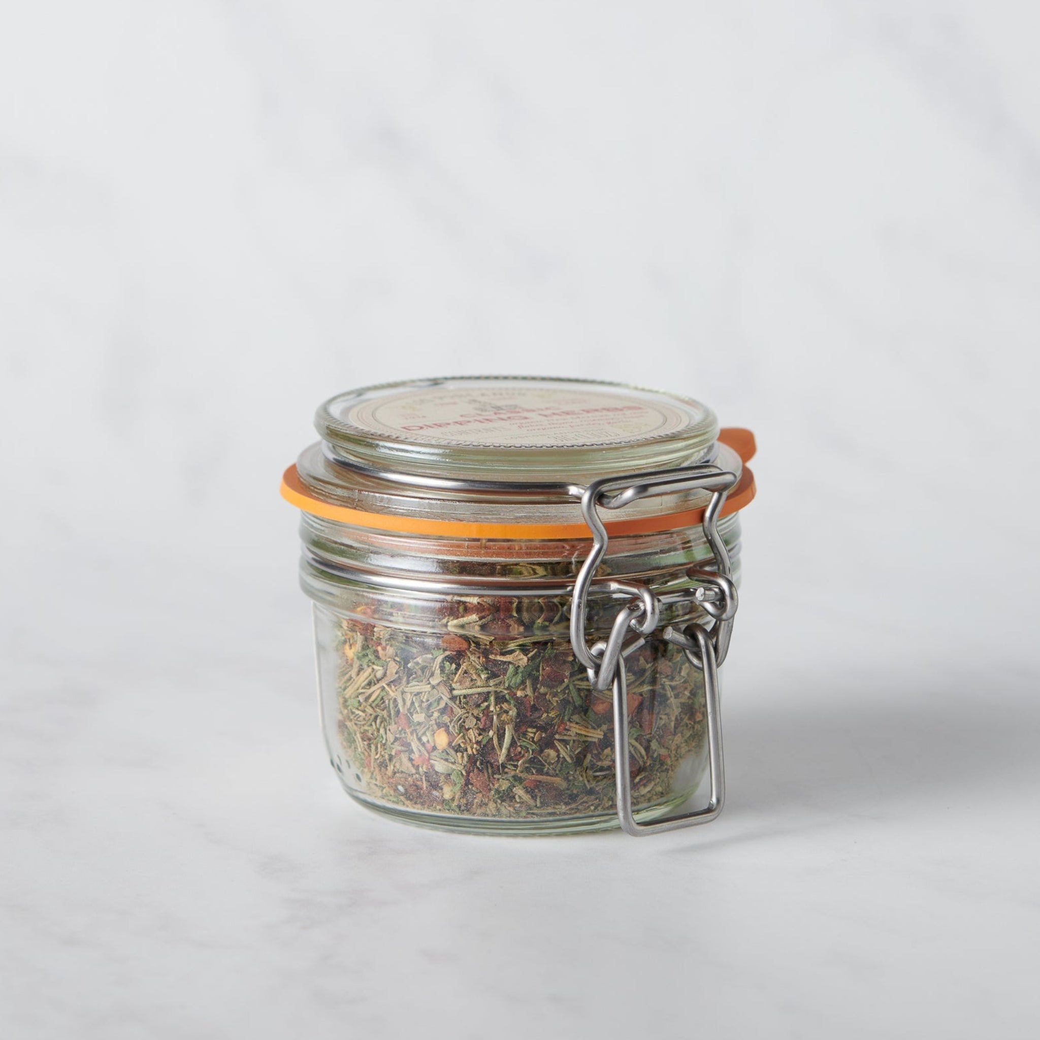 Classic Dipping Herbs from Los Poblanos in a glass jar containing a savory blend of farm-grown lavender and spices.