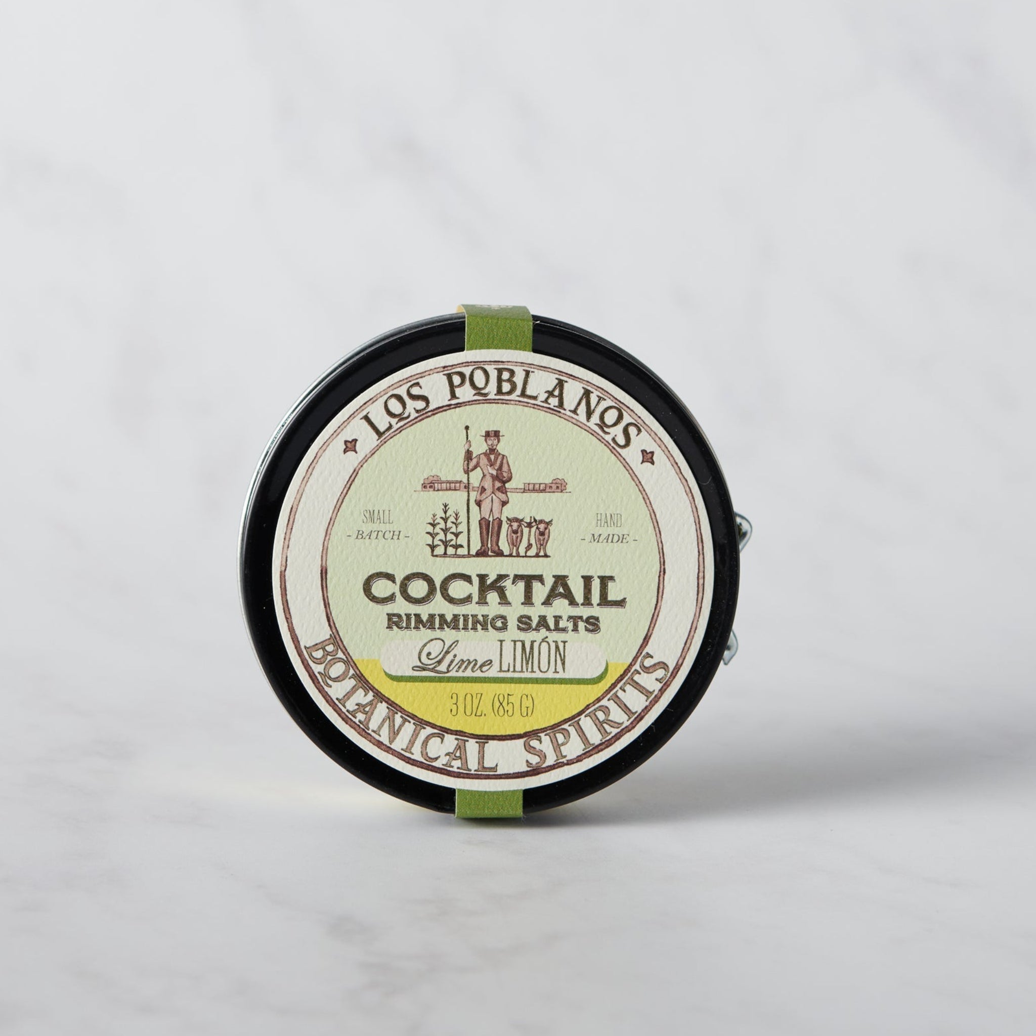 A round tin container of Los Poblanos Cocktail Rimming Salt with a green and white label, indicating Lime flavor.