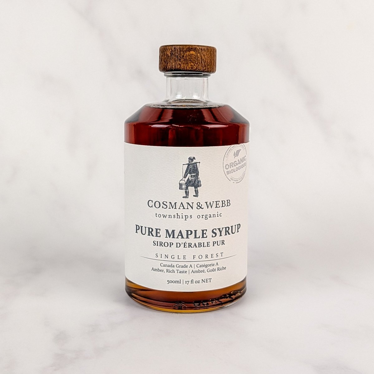Bottle of Cosman & Webb pure maple syrup on a white background
