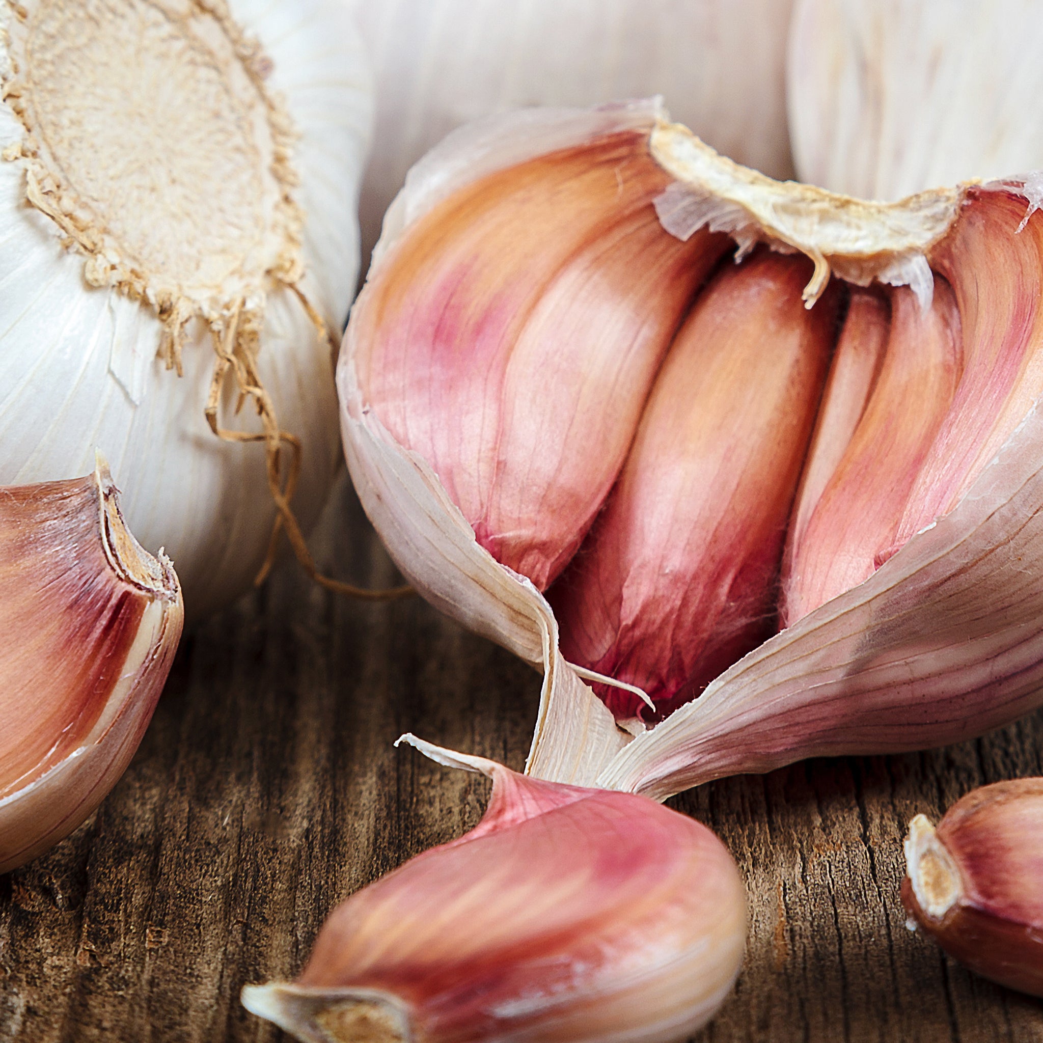 Close-up of garlic bulbs and cloves on a wooden surface