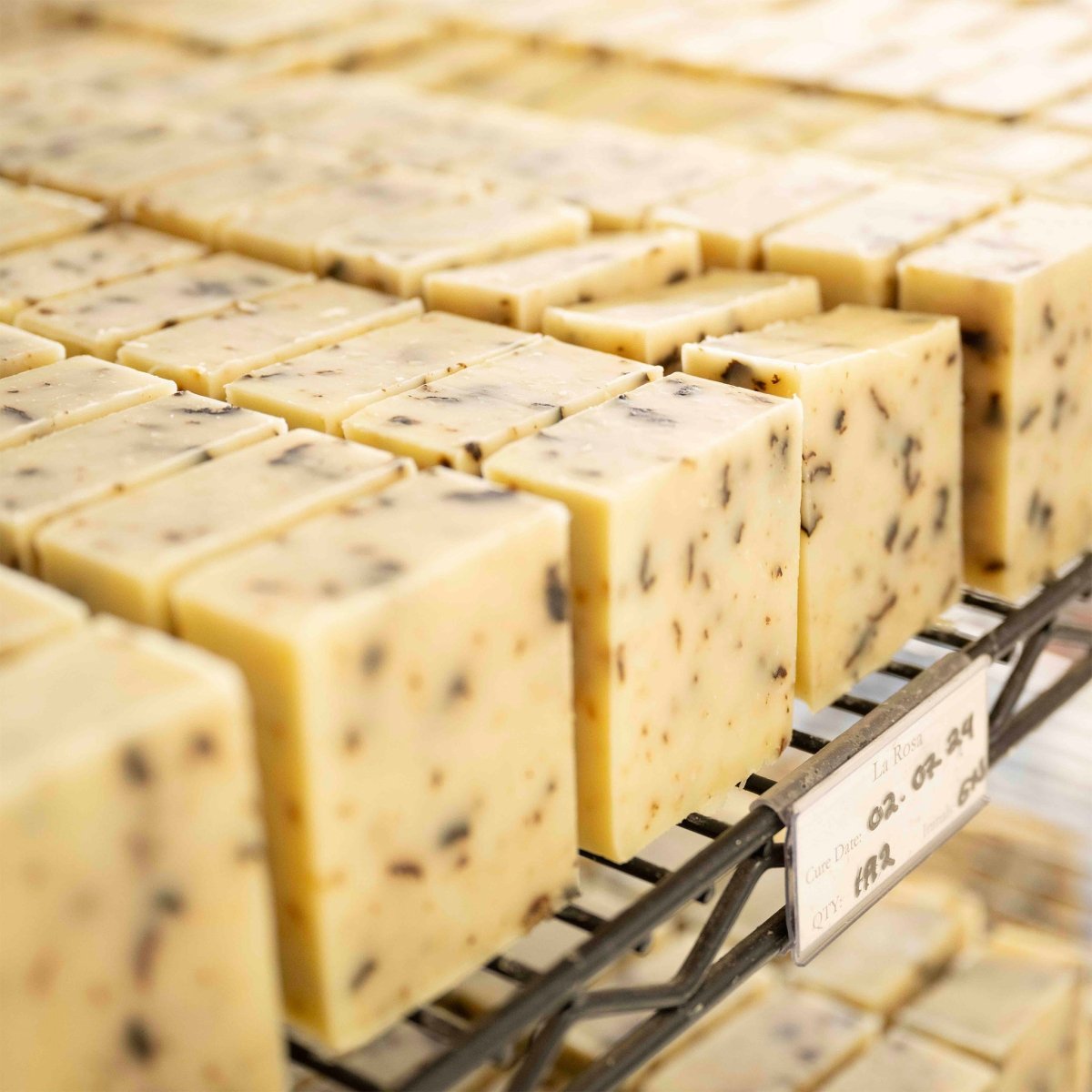 Close-up of square blocks of bar soap on a metal rack