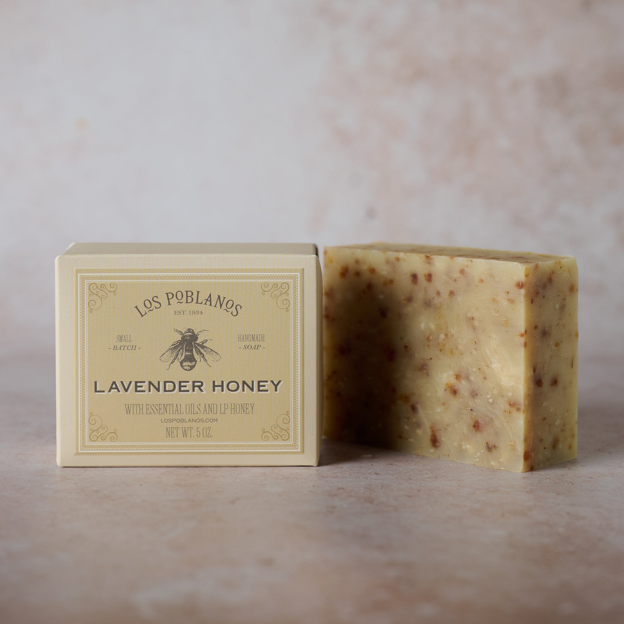 Bar of Los Poblanos Lavender Honey soap with packaging on a neutral background