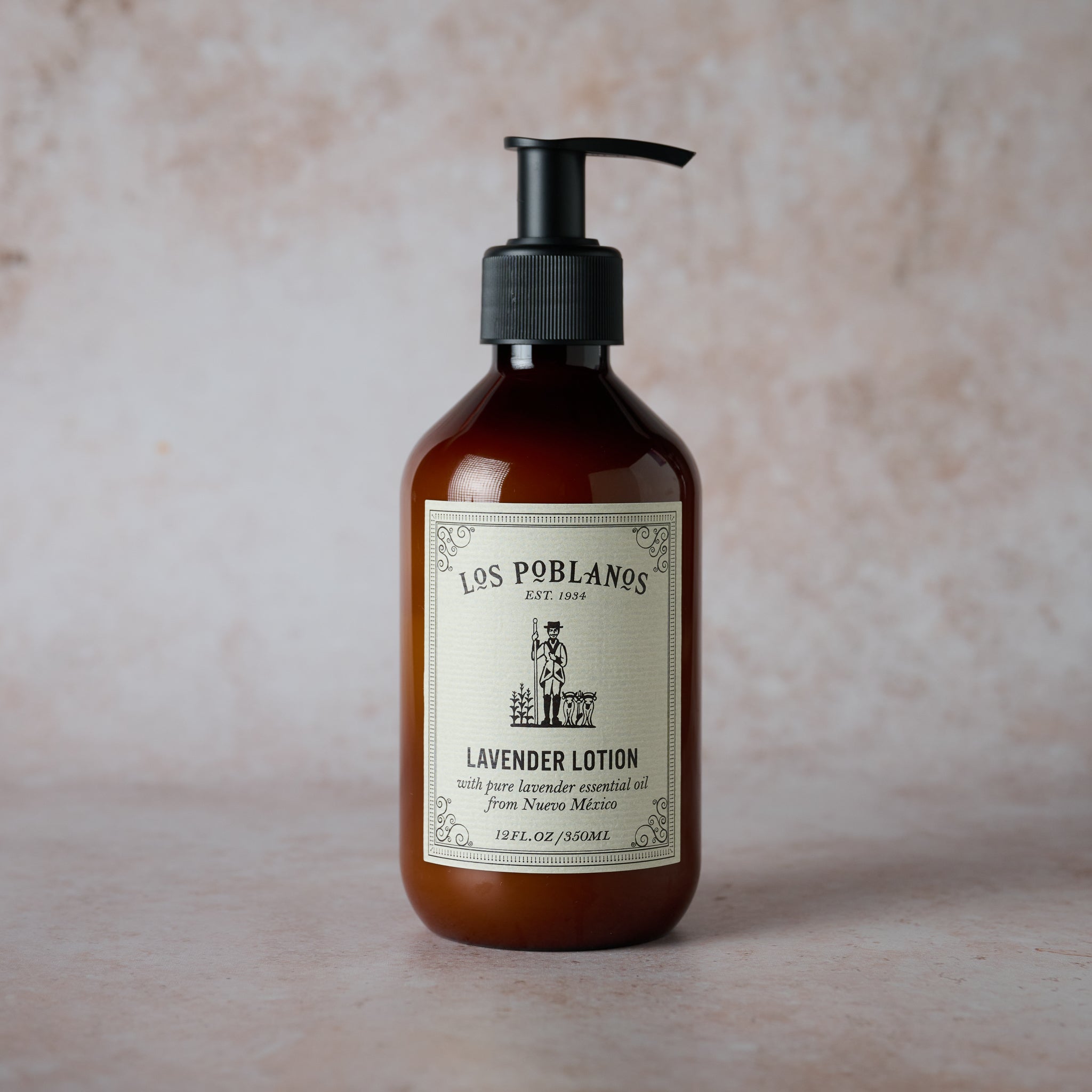 Brown lotion bottle with black pump and 'Los Poblanos' label on a beige background | Lavender Lotion | Los Poblanos Farm Shop