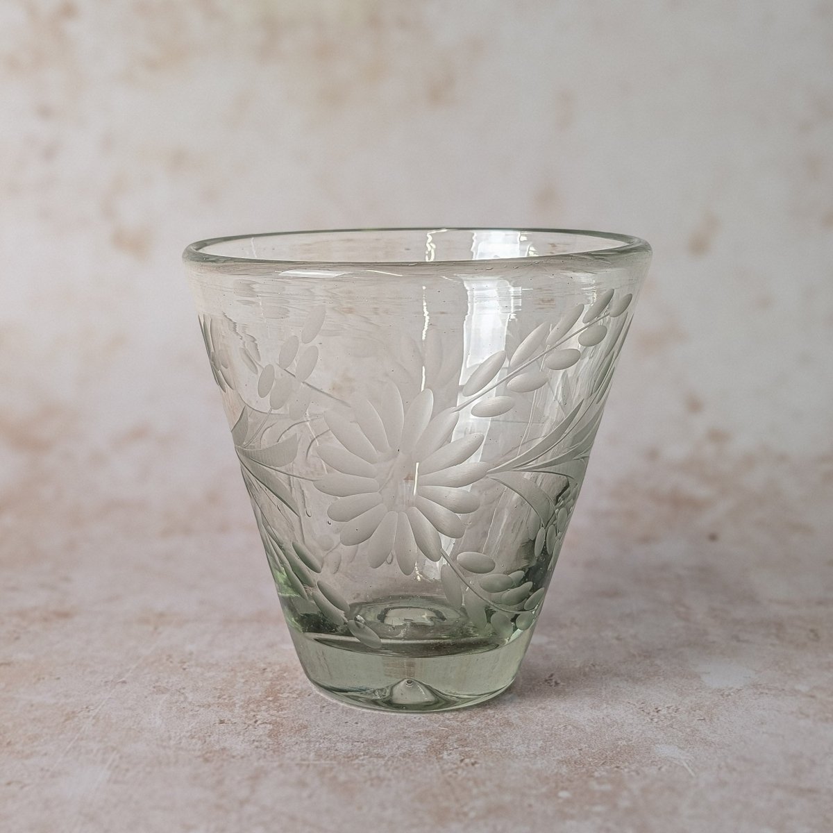 Decorative glass with floral patterns on a beige background