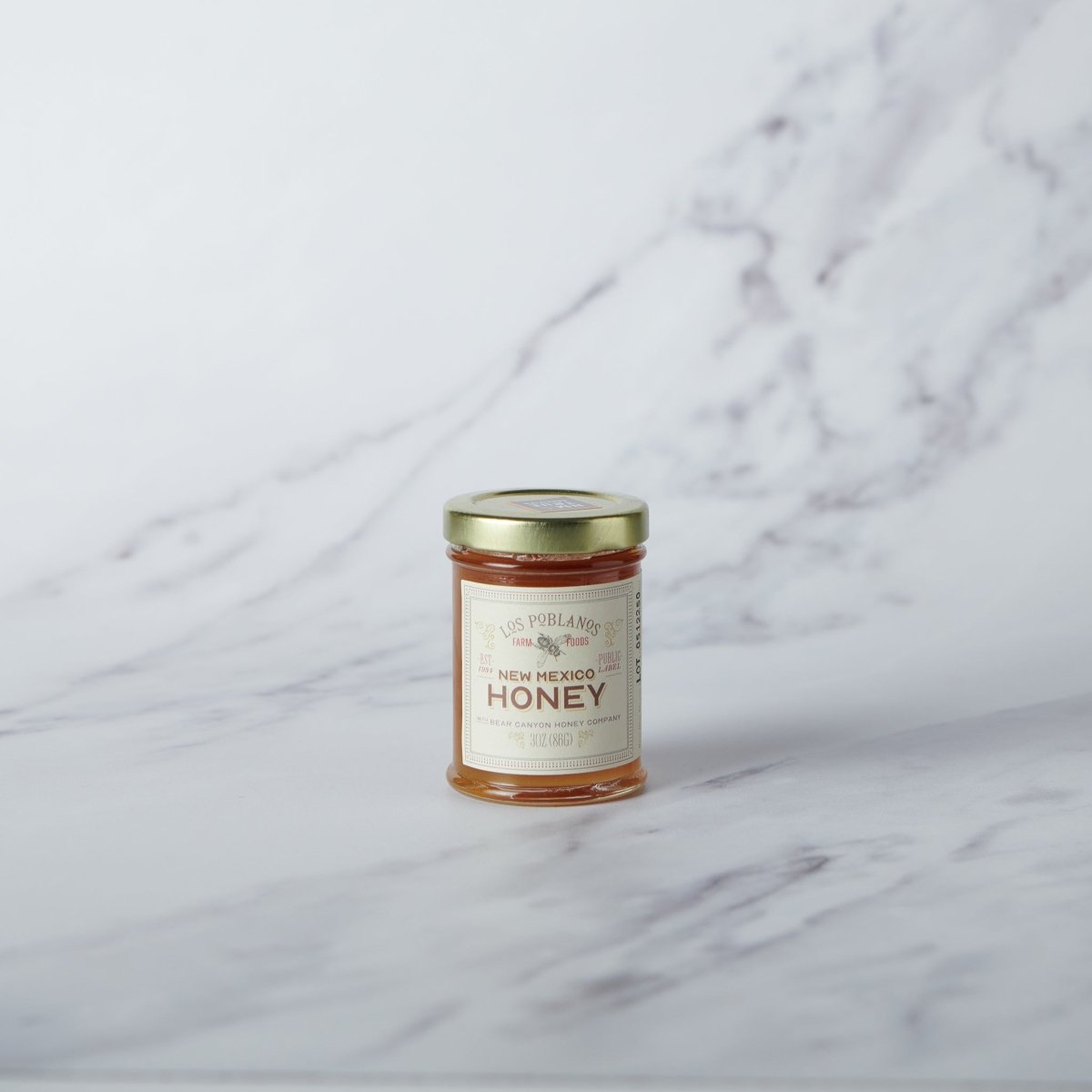 Jar of New Mexico honey on a marble surface
