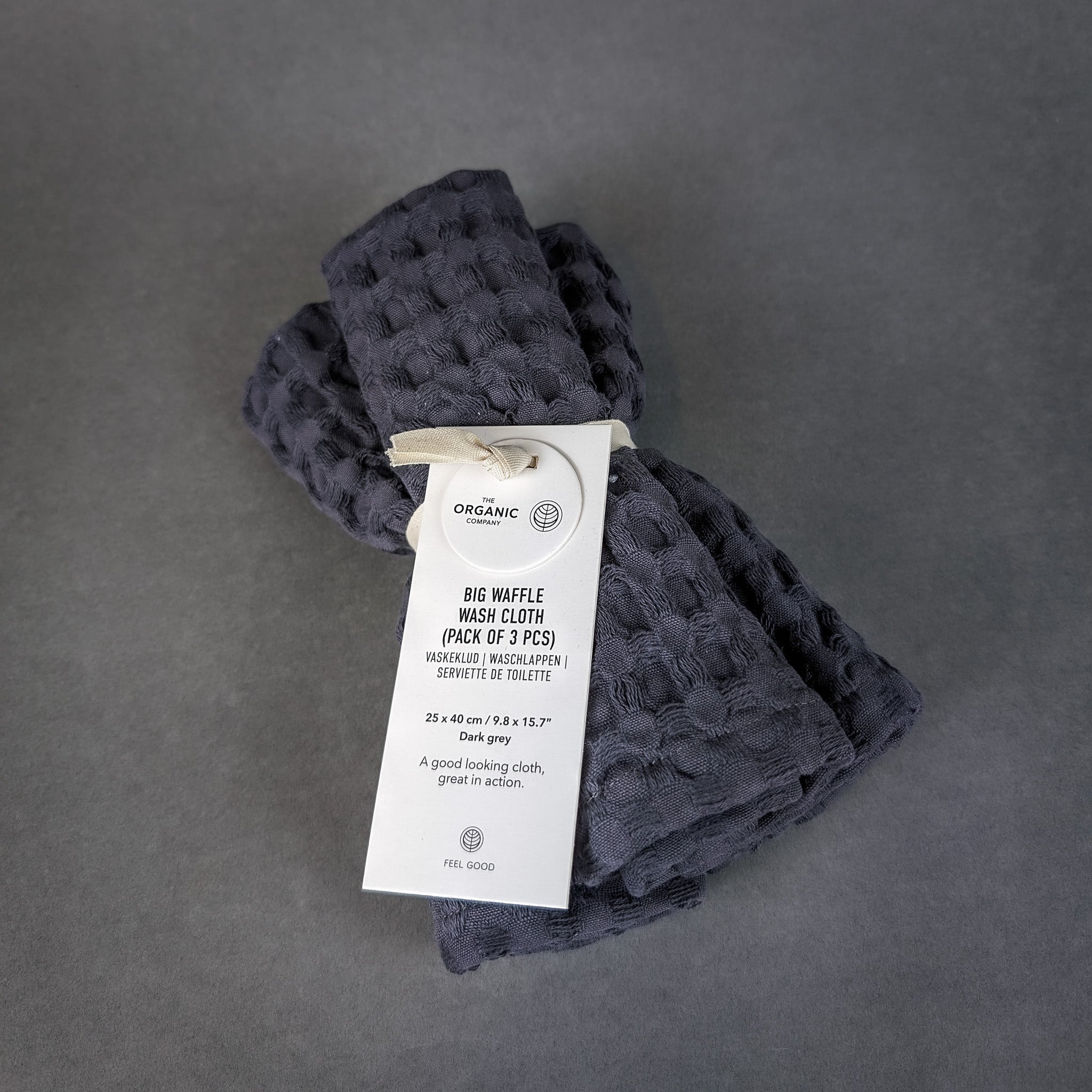 Dark gray waffle weave towels with a label on a gray background