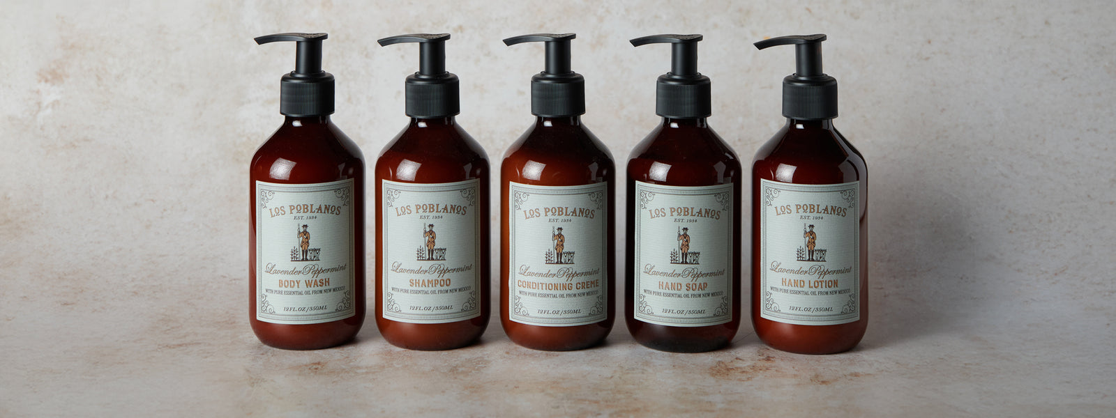 Five bottles of soap with labels on a light background