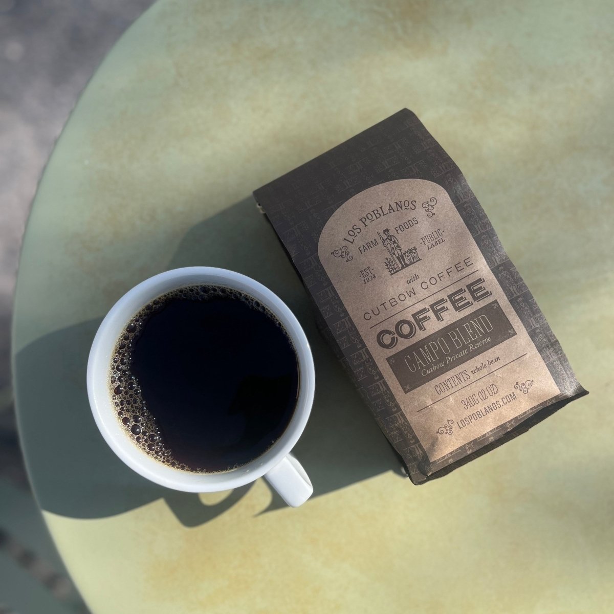 coffee cup with coffee and coffee bag with blurred background