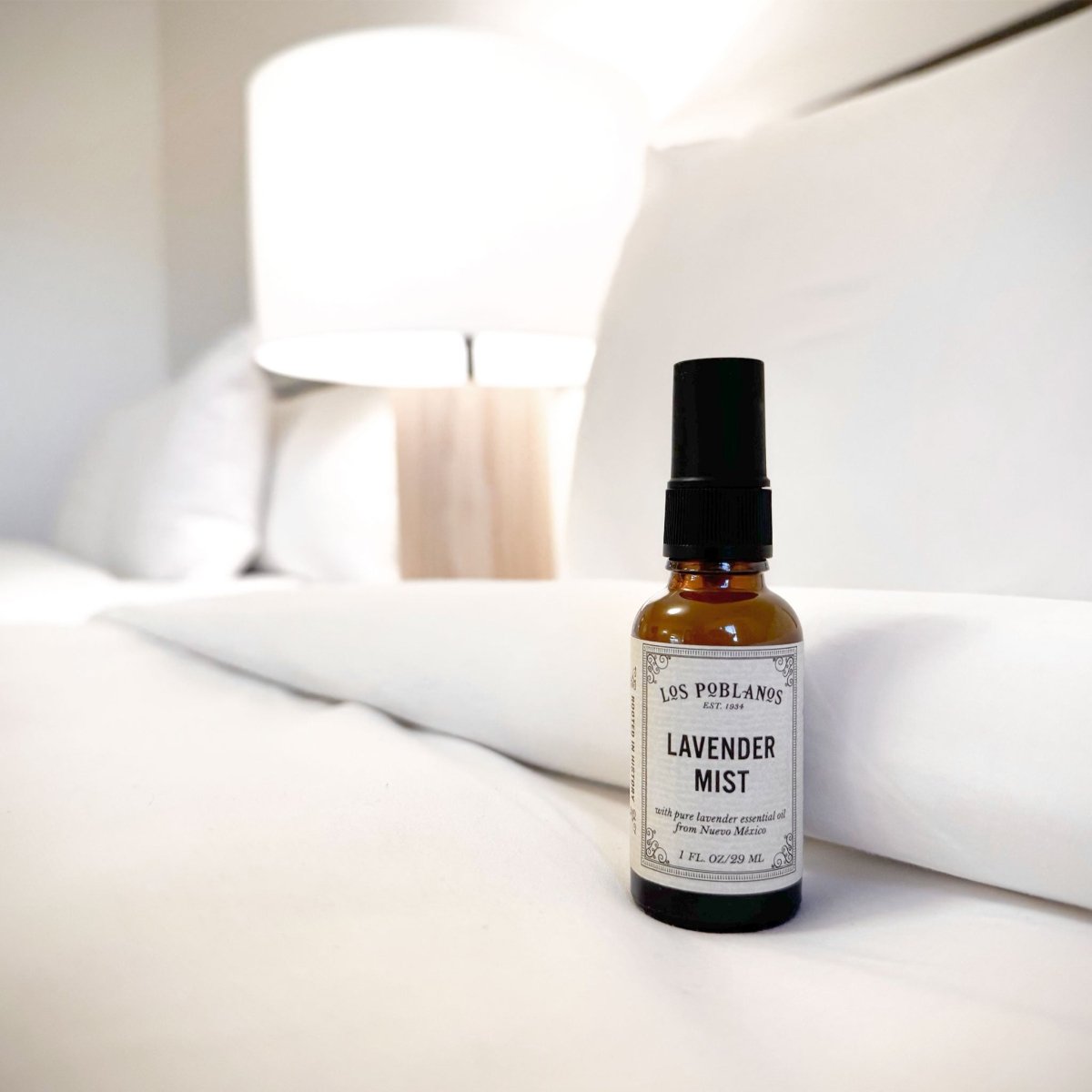 Bottle of Los Poblanos Lavender Mist on a hotel bed.