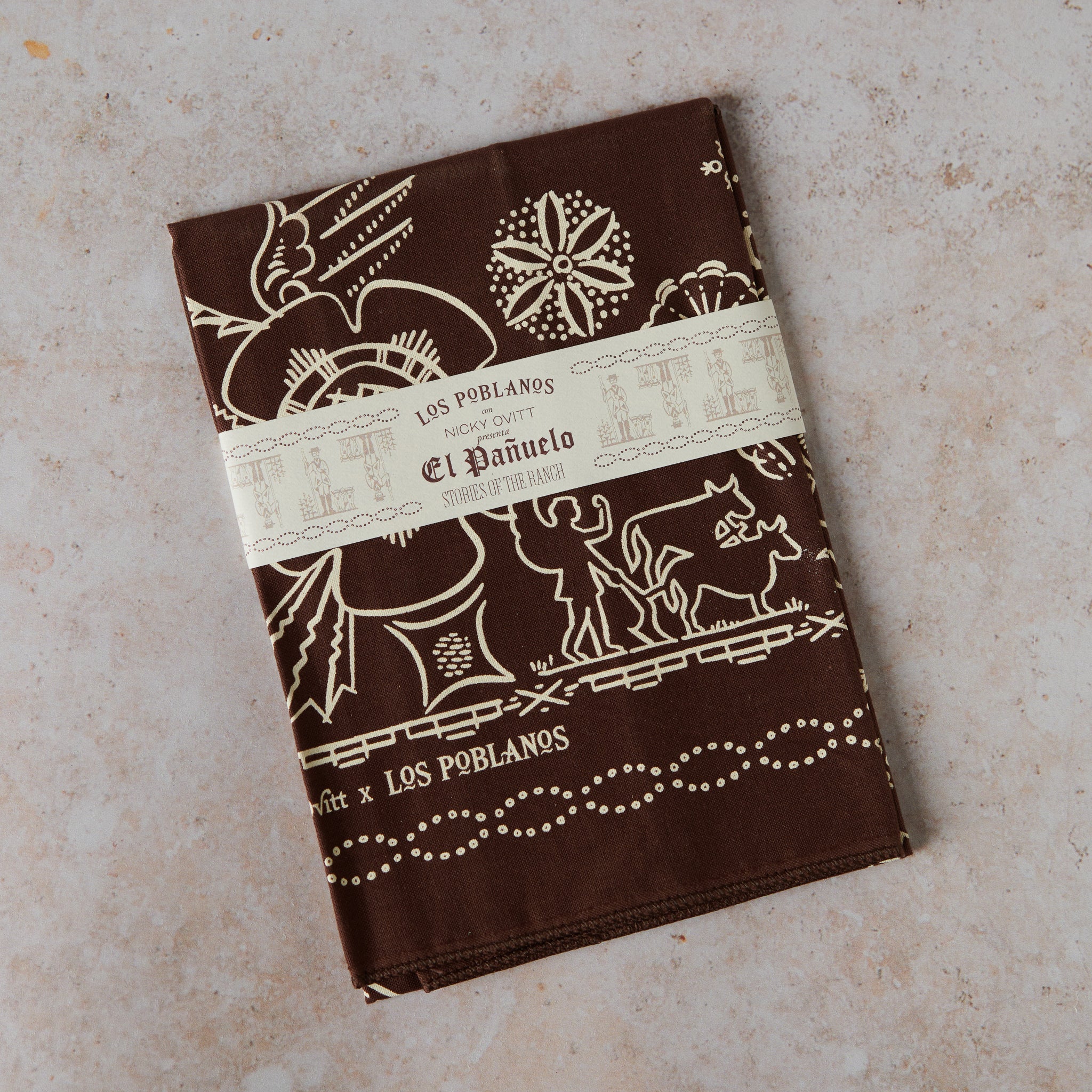 one chocolate bandana, with intricate Southwestern-inspired patterns on a textured surface.