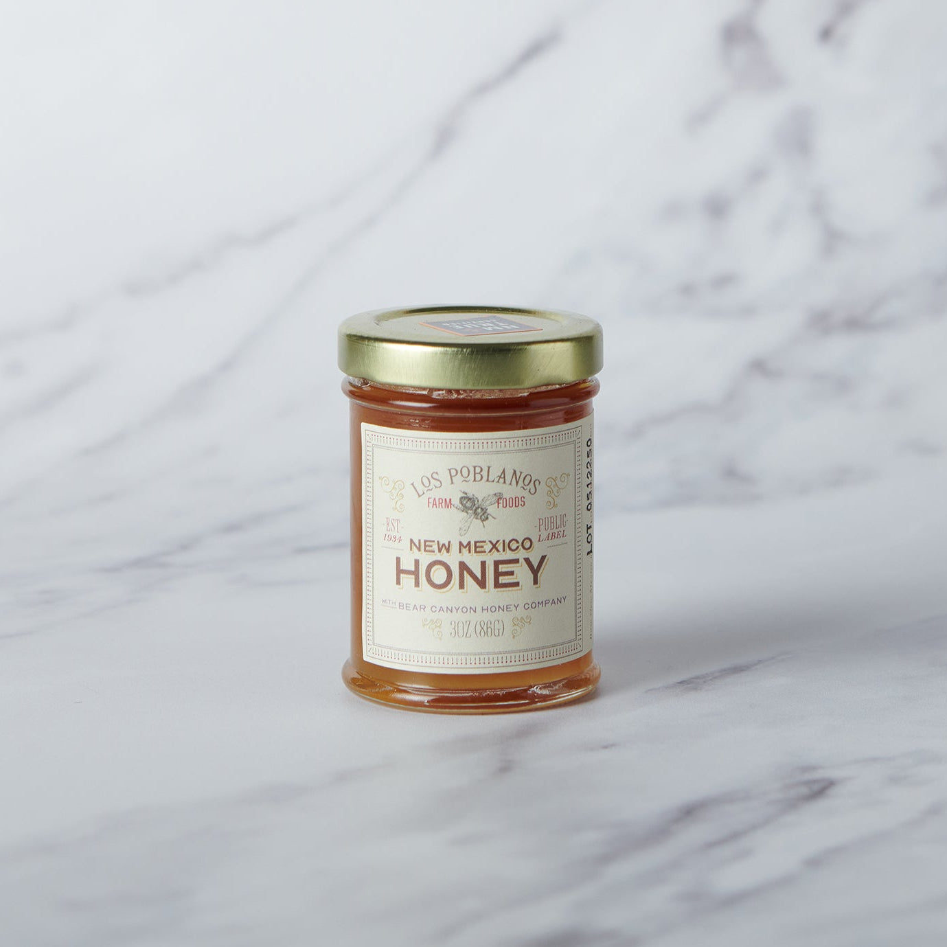 Jar of New Mexico honey on a marble surface
