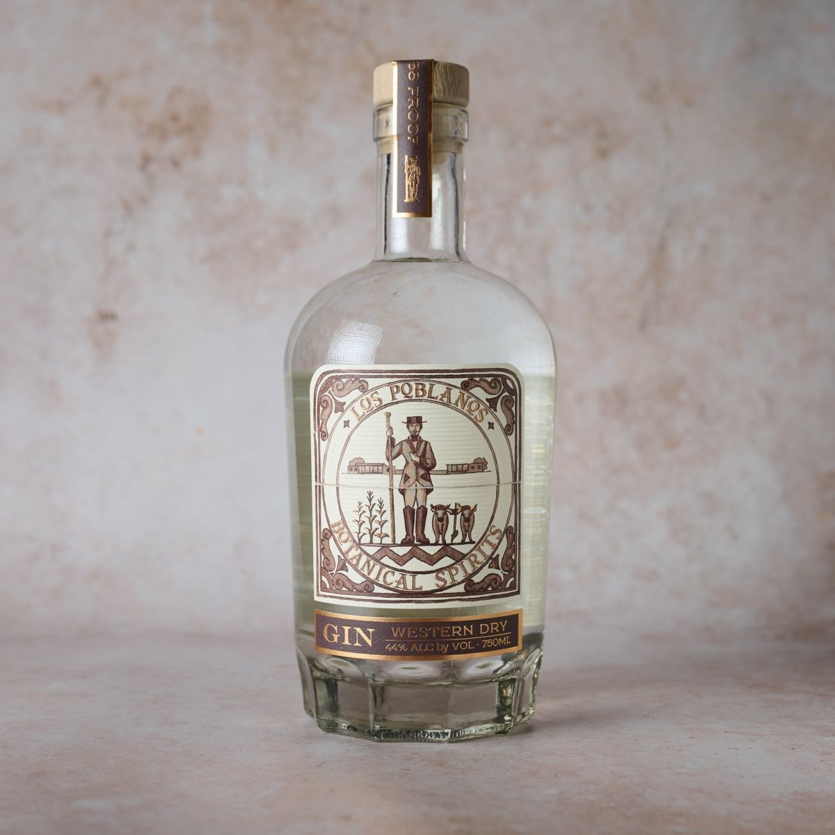 Bottle of gin with a label on a neutral background